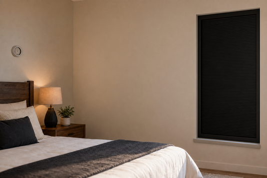 Fully closed black framed total blackout blind in a bedroom during summer heat