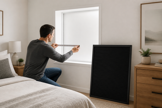 Homeowner checking whether a no-drill blackout blind will fit a rectangular bedroom window